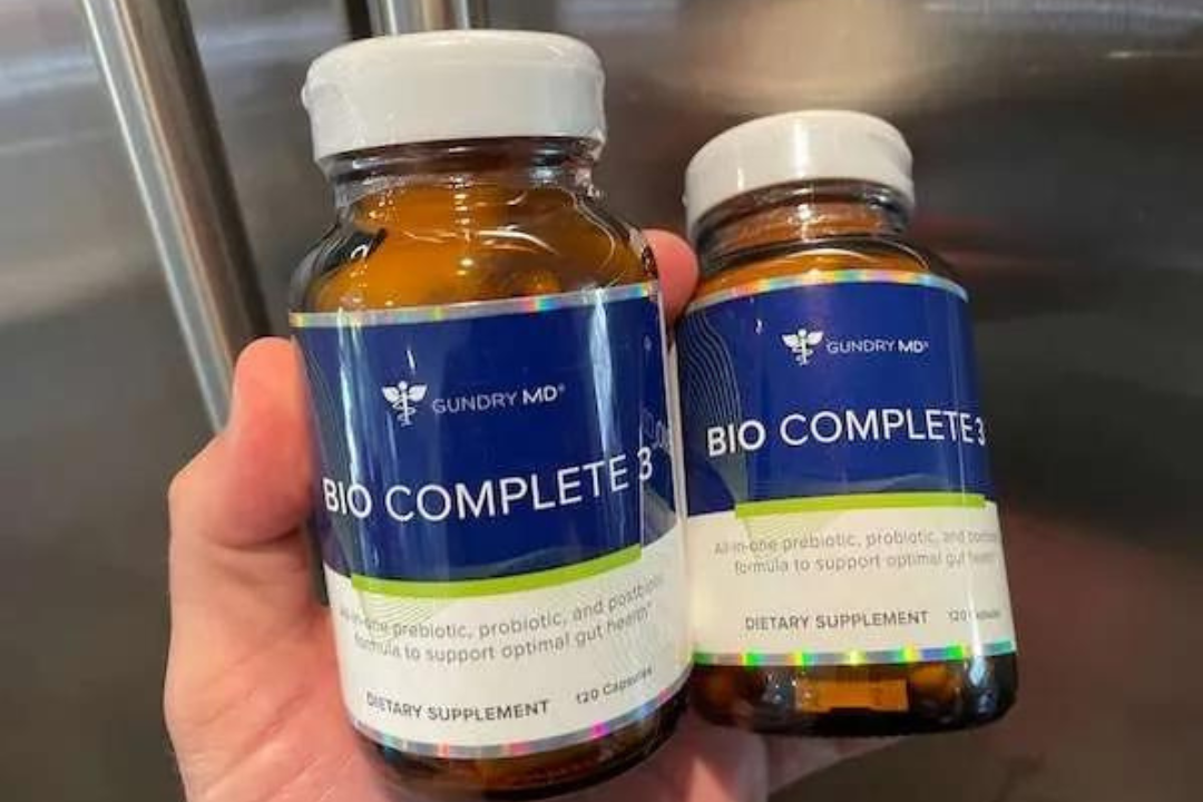 Two bottles of Gundry MD Bio Complete 3 held in a hand
